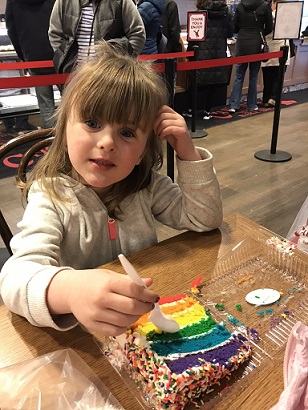 Megan eating Carlo's Bakery cake