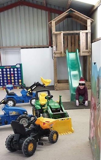 Megan on slide in indoor play area