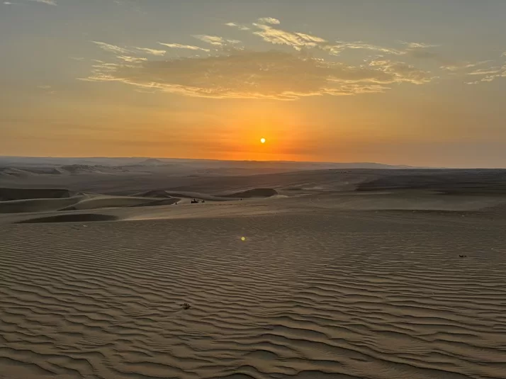 sandboarding as a family in Huacachina Peru sunset